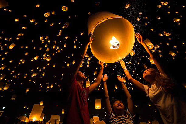 Thai's Family release sky lanterns to worship buddha's relics in yi peng festival, Chiangmai thailand